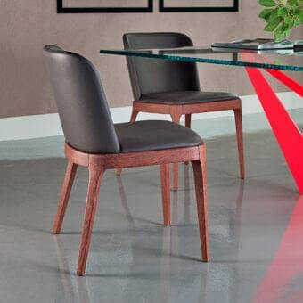 Superior Cattelan Italia Magda chair with gently sloping padded backrest and reddish-brown solid wood frame in leather-textured upholstery