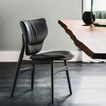 Elegant Cattelan Italia Dumbo chair with sculpted burned Oak stained ash wood and dark textile upholstery with matte finish