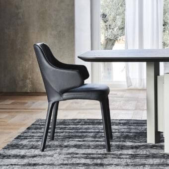 Sophisticated Cattelan Italia Wanda armchair fully upholstered in smooth matte black leather with tapered legs