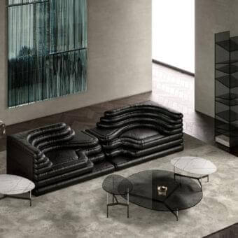 Distinctive Tonelli Design After9 coffee table with sleek black glass and a matte dark metal triangular base with gold accent