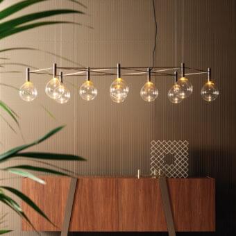 Distinguished Bonaldo Sofi suspension lamp with a warm amber borosilicate glass globe and burnished brass cylinder crafted in Italy
