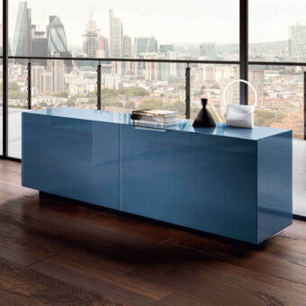 Lago plenum sideboard, deep blue gloss finish, rectangular form, minimalist design, set against hardwood floor and city view.