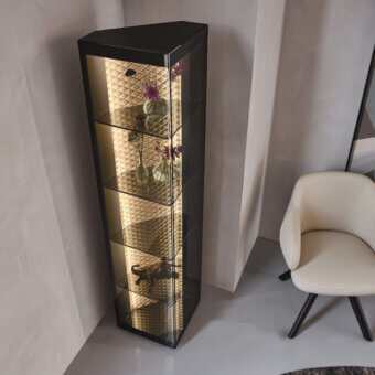 Elegant Cattelan Italia Atelier showcase with triangular form, smoked glass shelves and diamond-quilted leather backdrop illuminated by integrated lighting