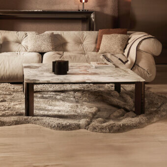 Elegant Visionnaire Vixen coffee table with beige and cream-veined marble top and polished stainless steel with textured aluminum base