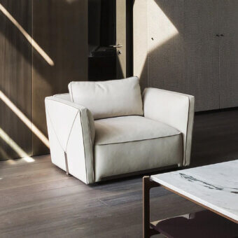Superior Visionnaire Bastian Still lounge chair with muted off-white textile upholstery and satin steel accents