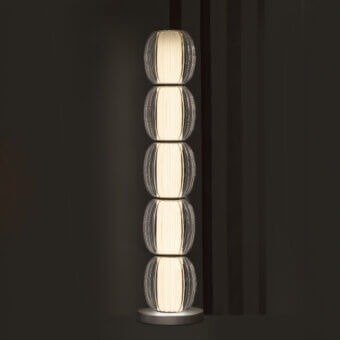Exceptional Contardi Alma Totem floor lamp with stacked translucent modules and brushed metal base emitting a creamy white glow