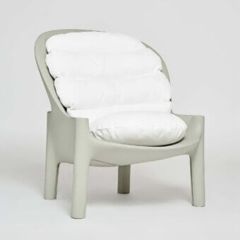 Refined Serralunga Balzac lounge chair with enveloping shape crafted in matte light grey-green recyclable LLDPE plastic