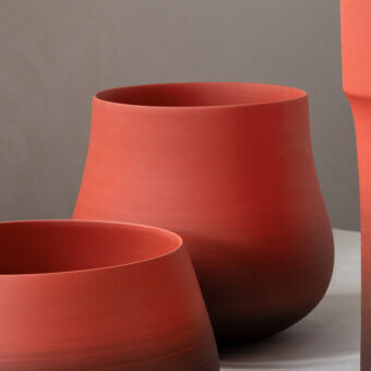 Superior Rina Menardi Delos vase sculpted from baked clay with a muted terracotta red and smooth matte finish
