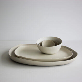 Distinguished Rina Menardi Quadritondi centerpiece with nested bowls and plates in warm grey matte ceramic