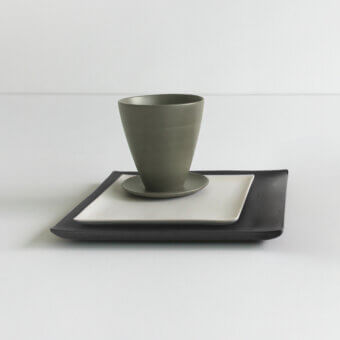 Exclusive Rina Menardi Vassoi Quadrati centerpiece tray with dark gray matte ceramic, olive green cup and bright white saucer