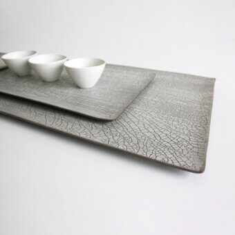 Distinguished Rina Menardi Vassoi Rettangolari tray set with uniquely cracked muted gray finish crafted for decorative use