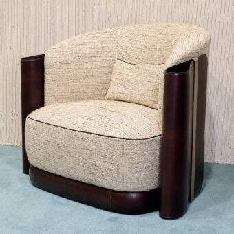 Contemporary Bellotti Ezio armchair with beige textile seat, dark brown leather arms, gold‑tone metal strip accent