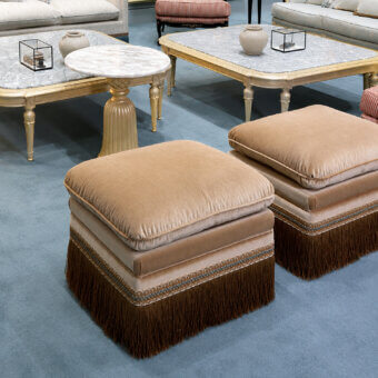 Sumptuous Bellotti Ezio 25-1008 ottoman in muted tan-beige velvet with satin-like sheen and multicolored textile fringe