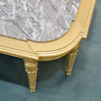 Luxury Bellotti Ezio coffee table with Antigua marble top, white meringue and patinated gold leaf finish, gold legs with carved scrollwork
