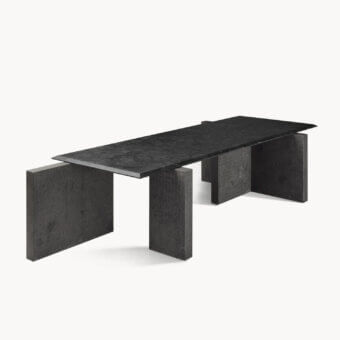 Distinguished Visionnaire Axiom table with dark charcoal stone and textured leather surface built on staggered block bases