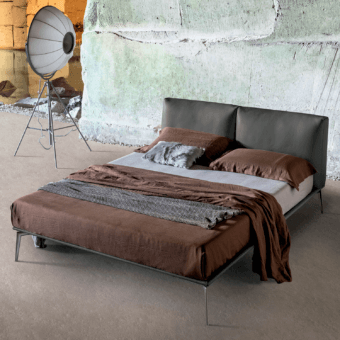 Luxury Alivar Papillon Bed with charcoal‑tinted leather headboard, texture, aluminium legs, brown and light‑grey linens