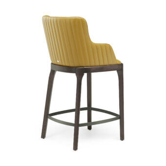 Elegant Cattelan Italia Magda Barré stool with mustard‑yellow synthetic leather upholstery and tapered wood legs in espresso grain and charcoal footrest
