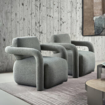 Luxury Ditre Italia Hairpin Lounge chair with low-profile steel tubular frame, medium grey textured upholstery, continuous cylindrical armrests