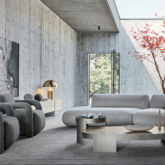 Elegant Ditre Italia lounge chair in matte gray textured fabric with vertical grain, steel tubular hairpin armrests, hardwood plywood frame