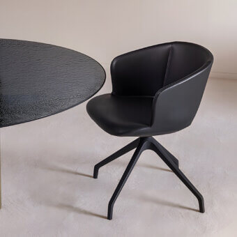 Elegant Sovet Italia Alika Swivel armchair in all‑black synthetic goud‑ek with soft subtle matte sheen