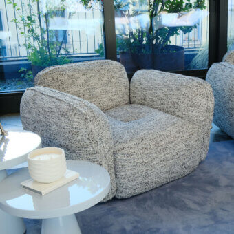 Architectural Furla Casa Moonstone lounge chair in mottled light gray textured fabric with solid black beech wood feet