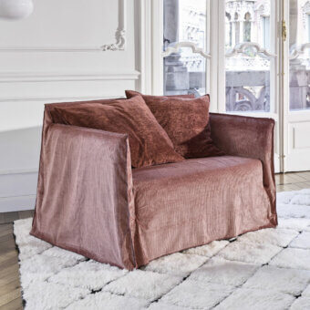Luxury Gervasoni Ghost lounge chair in muted dusty‑rose ribbed textile slim frame padded cushioned with Dacron down