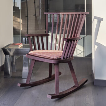 Sophisticated Gervasoni Gray 29 rocking chair crafted from deep dark reddish-brown ash wood with multi-colored textile cushion