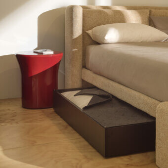 Sophisticated Kristalia Dimora bed in textured beige textile with black lacquered melamine and dark charcoal storage drawer