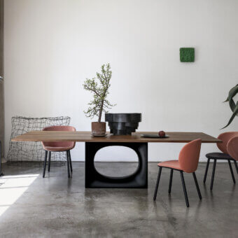 Elegant Kristalia Holo table with wooden top natural grain finish and matte black steel base featuring sculpted oval opening