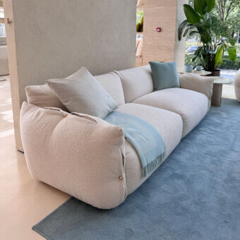 Exquisite Furla Casa Cherry Blossom sofa in off-white textured textile with organic silhouette and black beech wood feet