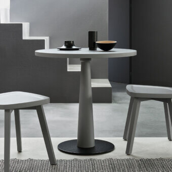 Refined Gervasoni Gray 39 Bistrot table with circular top, tapered central pedestal and solid black base in matte finish