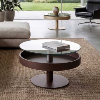 Prestige Naos Levante round coffee table with glossy clear glass top, matte dark brown frame and silver-toned metal pillar