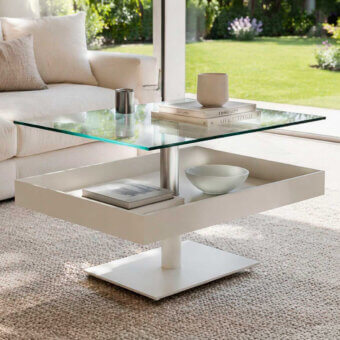 Distinguished Naos Levante rectangular coffee table with transparent glass top and matte white base over satin metal columns