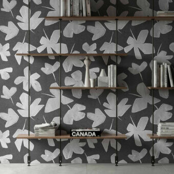 Sophisticated Tecnografica wallcovering featuring modern botanical brushstroke leaf motifs in dark charcoal and off white with textured finish