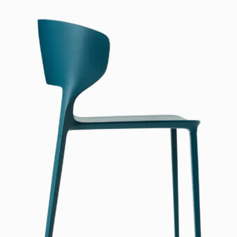Luxury Desalto Koki chair in deep teal integral polyurethane shell with matching lacquered steel legs and matte finish