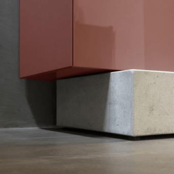 Luxury Mogg Block sideboard in terracotta high-gloss lacquered wood resting upon a solid industrial concrete base frame