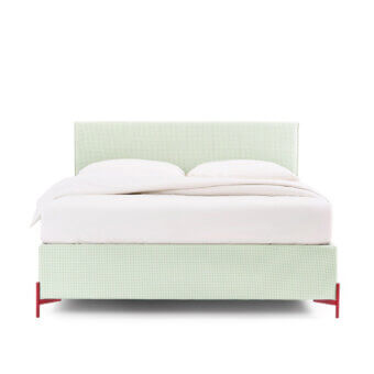 Elegant Noctis Cosmo bed with plush green and off-white checkered textile upholstery and slender vibrant red metal feet
