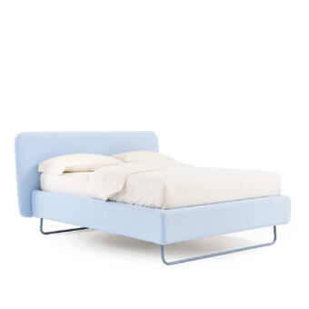 Elegant Noctis Doxy Wide bed in light blue textile upholstery featuring rounded headboard and metal base