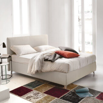 Elegant Noctis Manuel bed in light beige textured textile with rectangular padded headboard and slender tapered feet