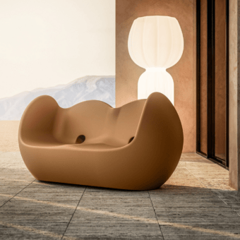 Luxury Slide Blossy sofa in ochre polyethylene with a smooth matte finish and an organic sculptural rocking silhouette